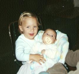 2 years, holding my sister.